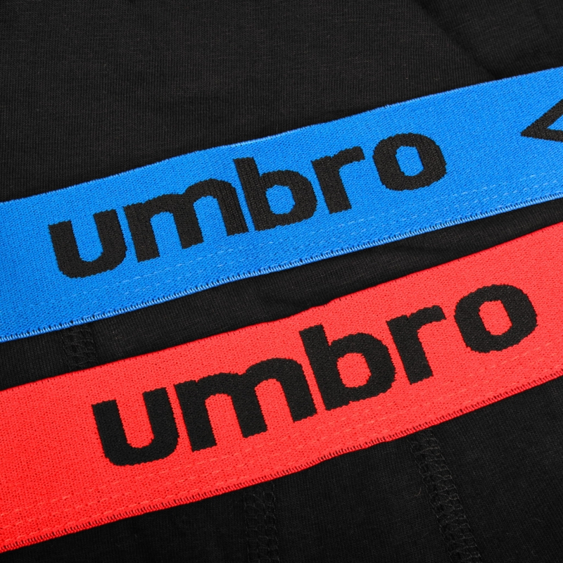 Zbliżenie na elastyczną gumę z kolorowym logo Umbro.