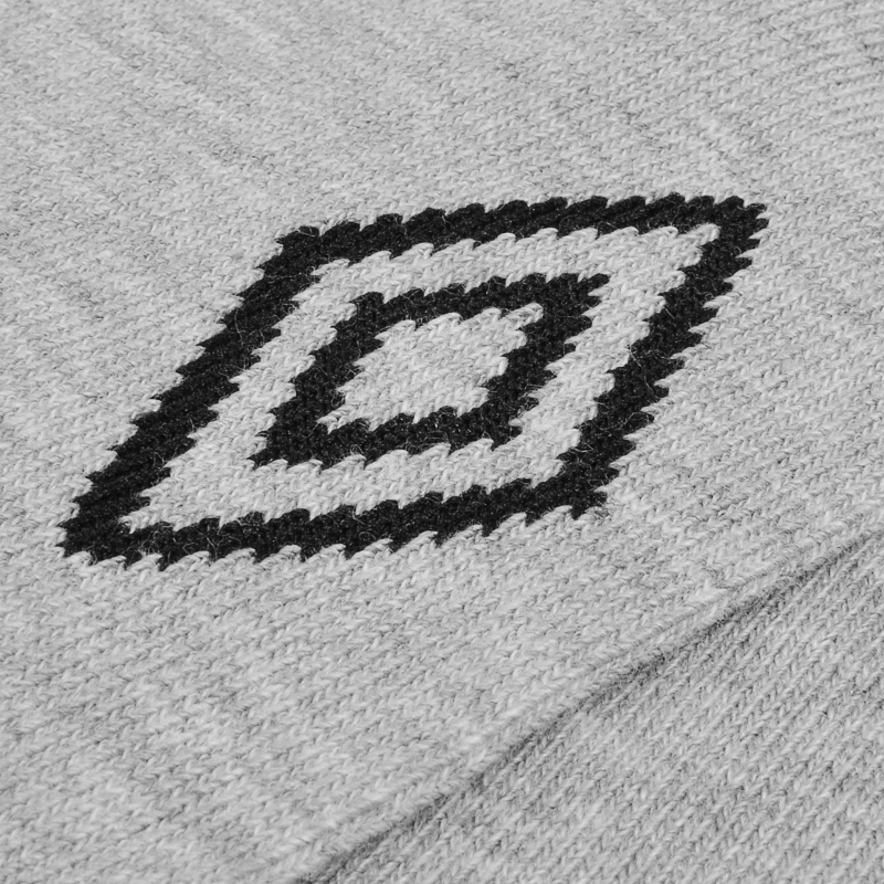 Zbliżenie na logo Umbro umieszczone na boku szarych skarpet