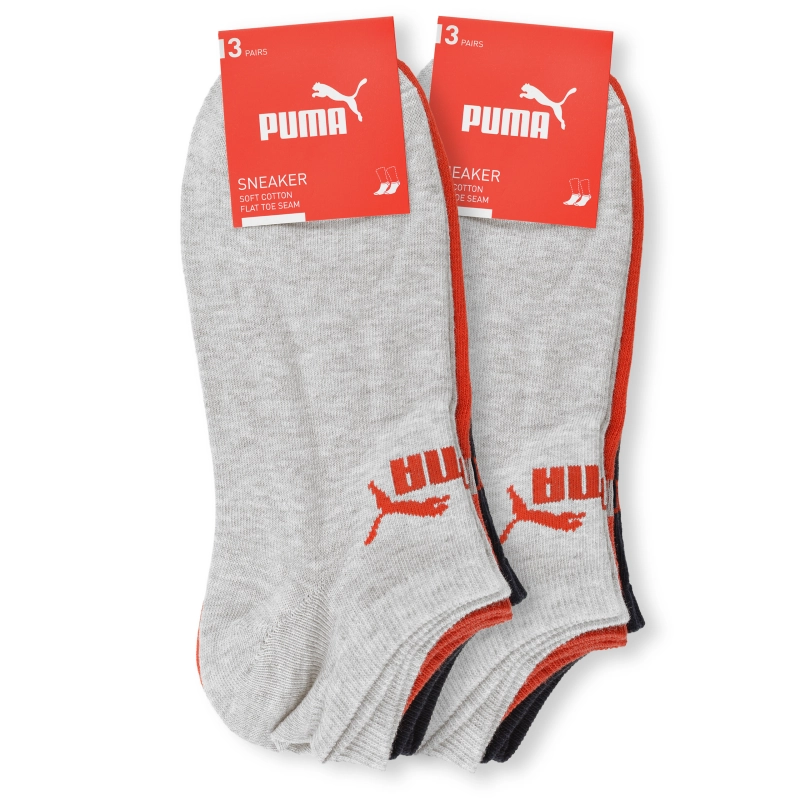 Szare stopki PUMA przy czerwonych kartach z logo marki