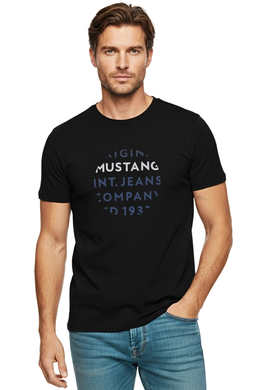 Model w czarnej koszulce Mustang z nadrukiem na piersi.